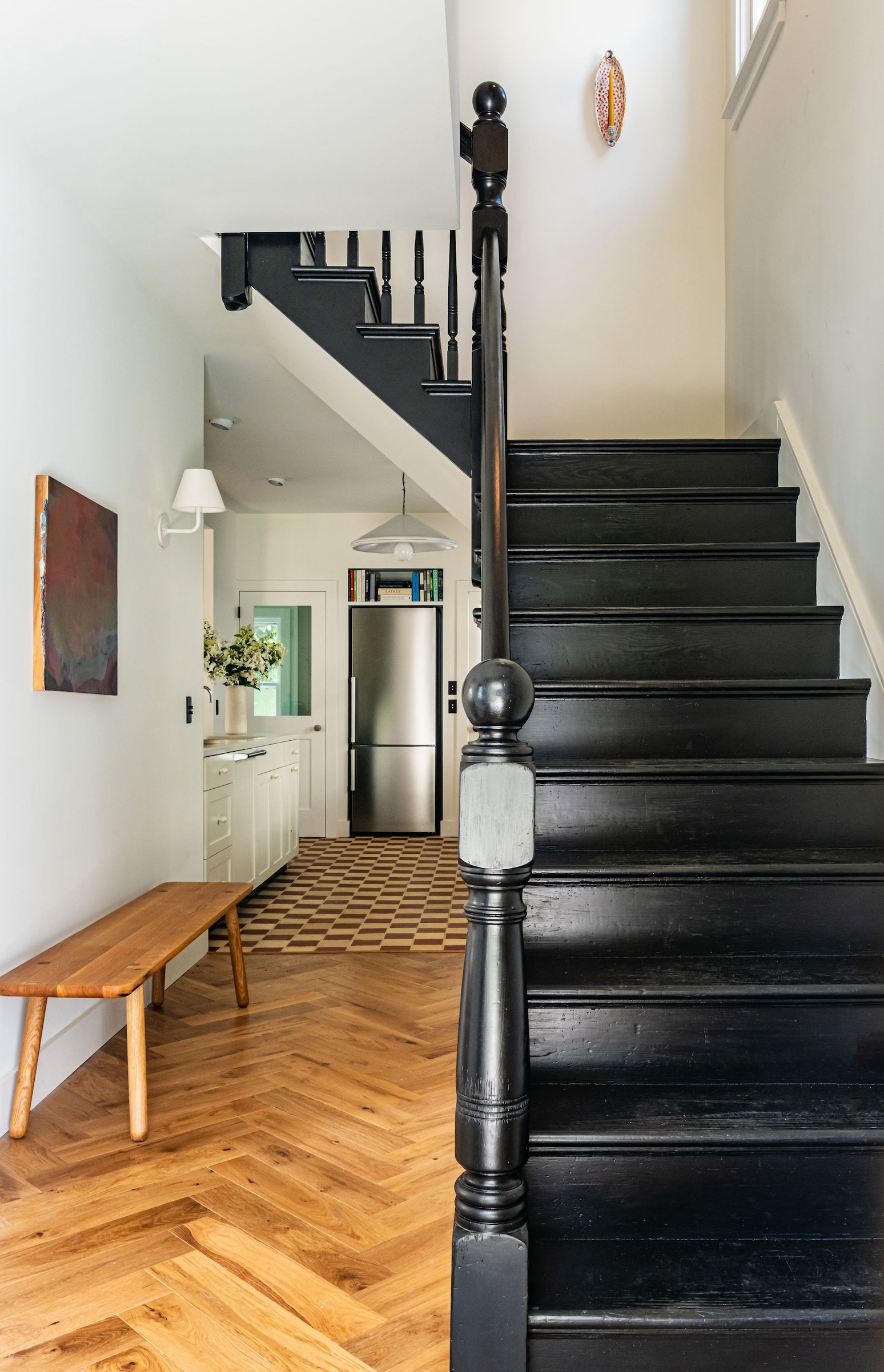 the entry hall has a new herringbone wood floor leading to the tiled kitchen. & 18